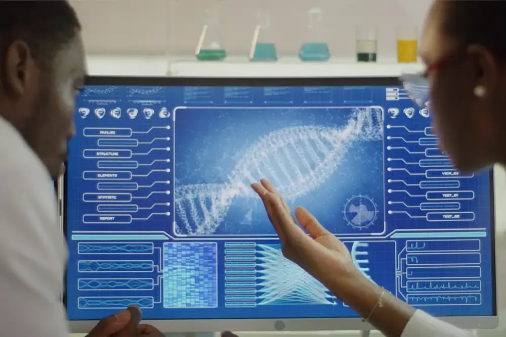 2 scientist looking at genome on a computer