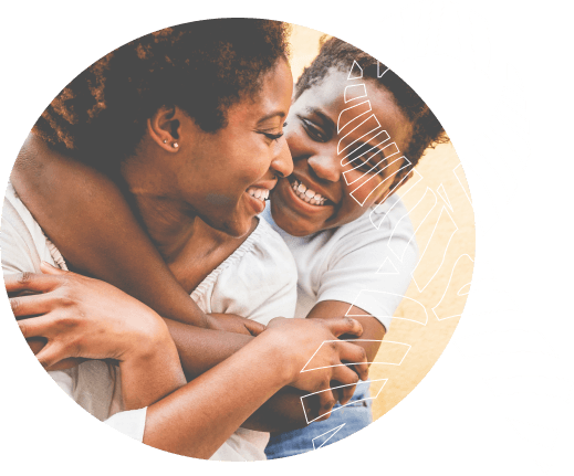 Image of a mother hugged by her teenage daughter.