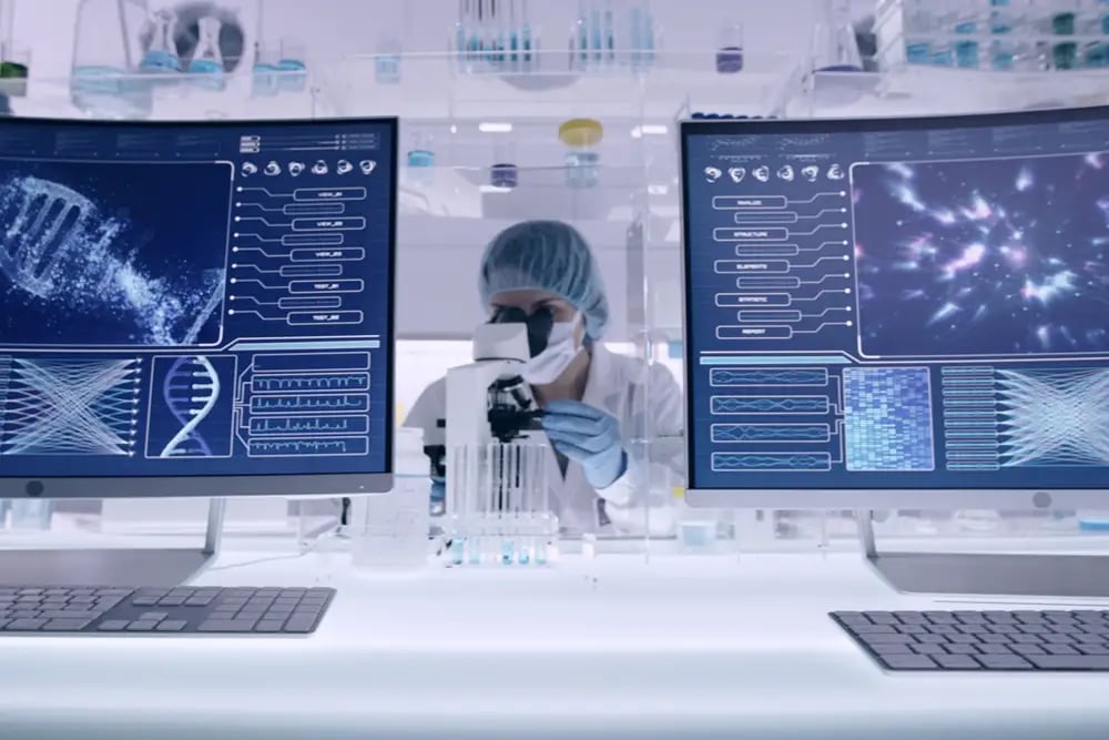female scientist in a lab with large computer screens
